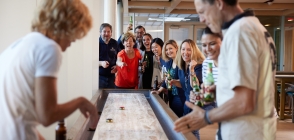 Thunderbird staff enjoy a game of shuffleboard in the Pub