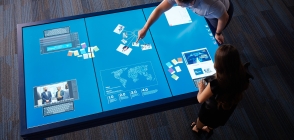 Students work on a tabletop computer in Thunderbird innovation lab at global headquarters
